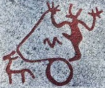 A Nordic Bronze Age rock petroglyph of a man in a chariot pulled by a goat